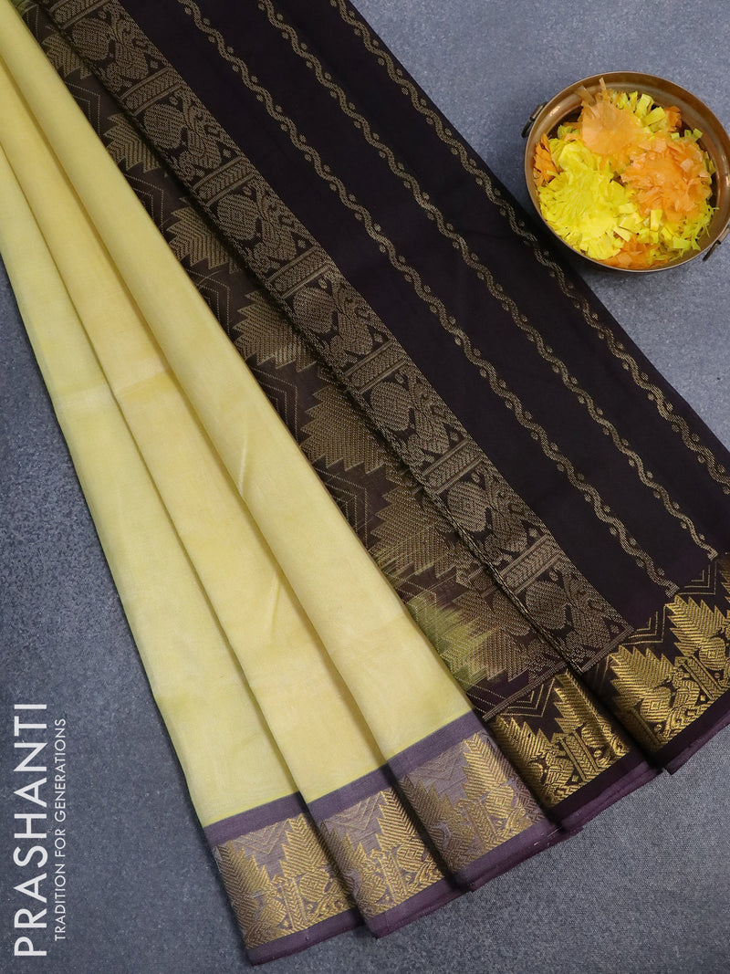 Silk cotton saree pale yellow and deep jamun shade with plain body and temple design zari woven border