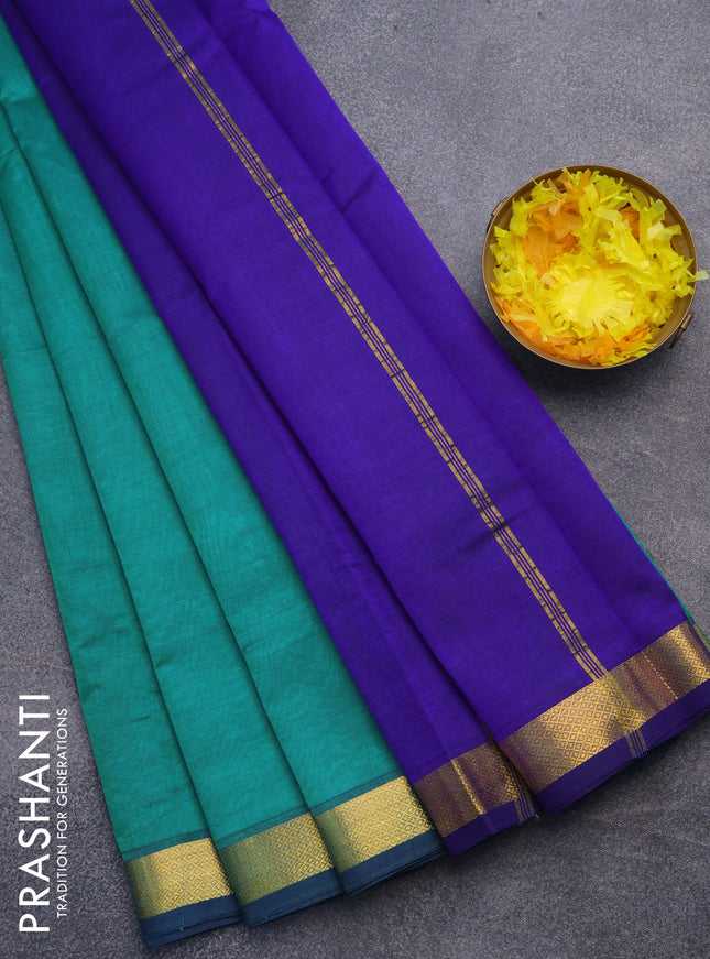 Silk cotton saree teal green and blue with plain body and small zari woven border
