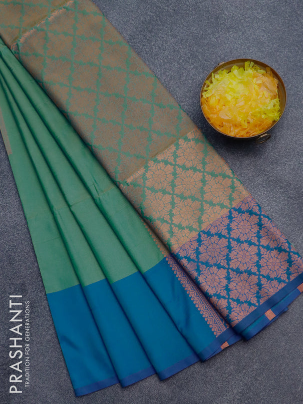 Semi soft silk saree dual shade of green and cs blue with copper zari woven box type buttas and simple border