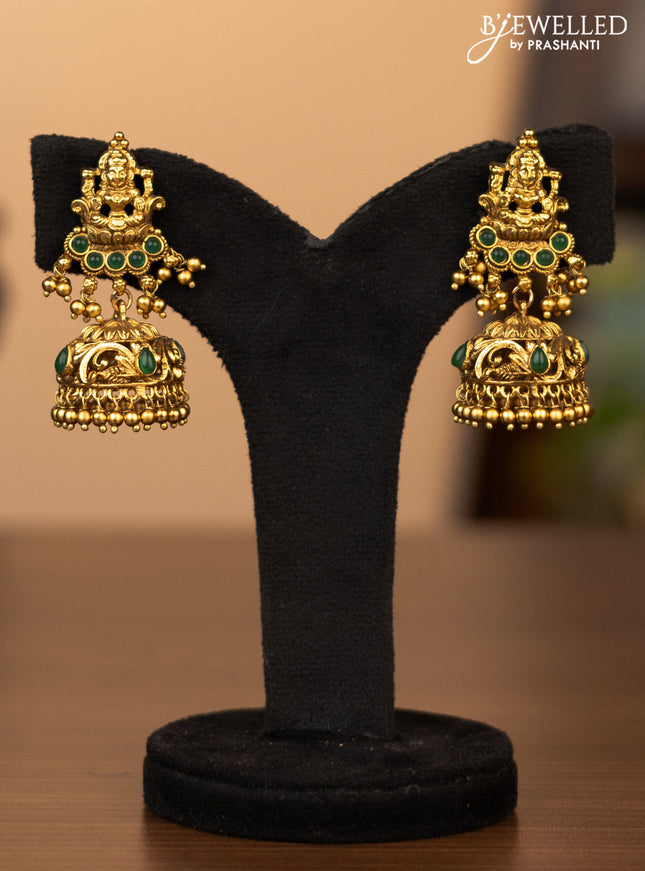 Antique necklace lakshmi pendant with green kemp stones and golden beads hanging