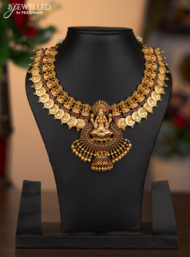 Antique necklace lakshmi pendant with kemp stones and golden beads hanging without earrings