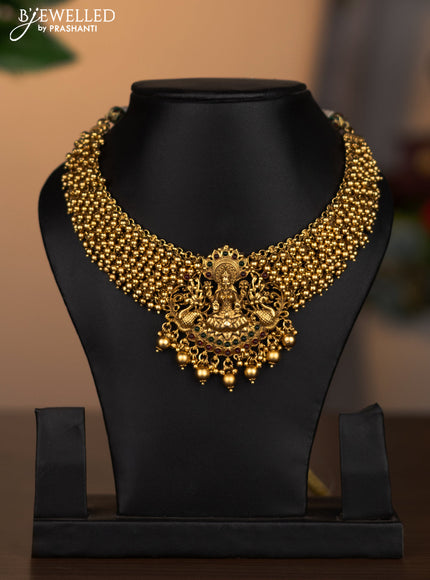 Antique necklace lakshmi design with kemp stones and golden beads hanging without earrings