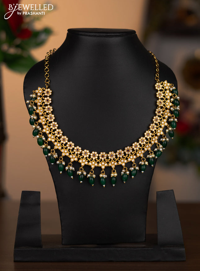 Antique necklace with pink kemp & cz stones and pearl & green beads hanging without earrings