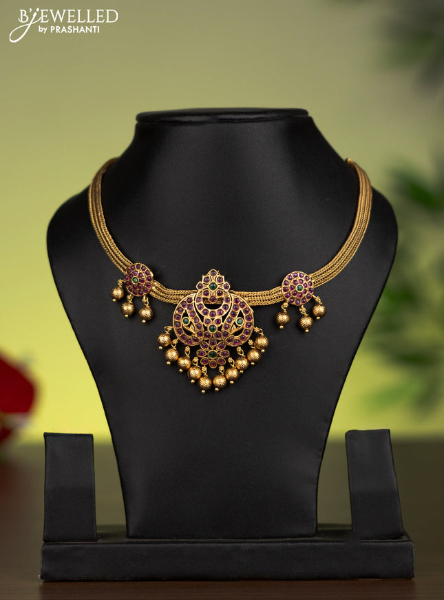 Antique attigai necklace with kemp stones and golden beads hanging without earrings