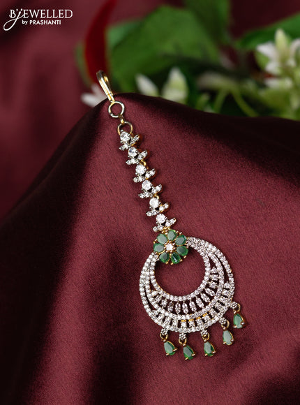 Zircon maang tikka with emerald & cz stones and hangings in gold finish