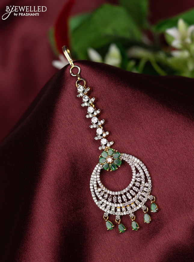 Zircon maang tikka with emerald & cz stones and hangings in gold finish