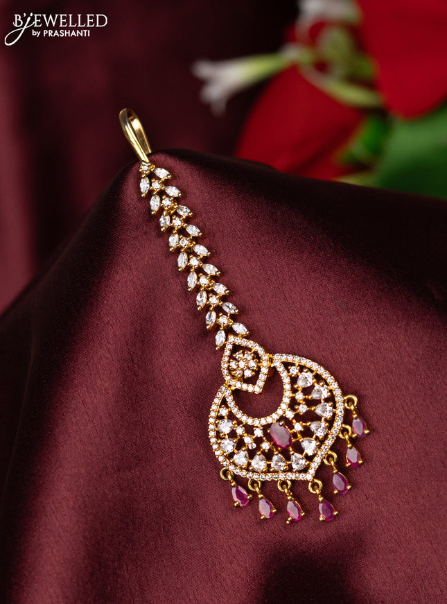 Zircon maang tikka with ruby & cz stones and hangings in gold finish