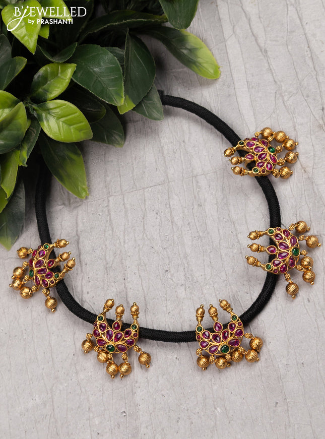 Black thread necklace with kemp stone chandbali pendant and golden beads hanging without earrings