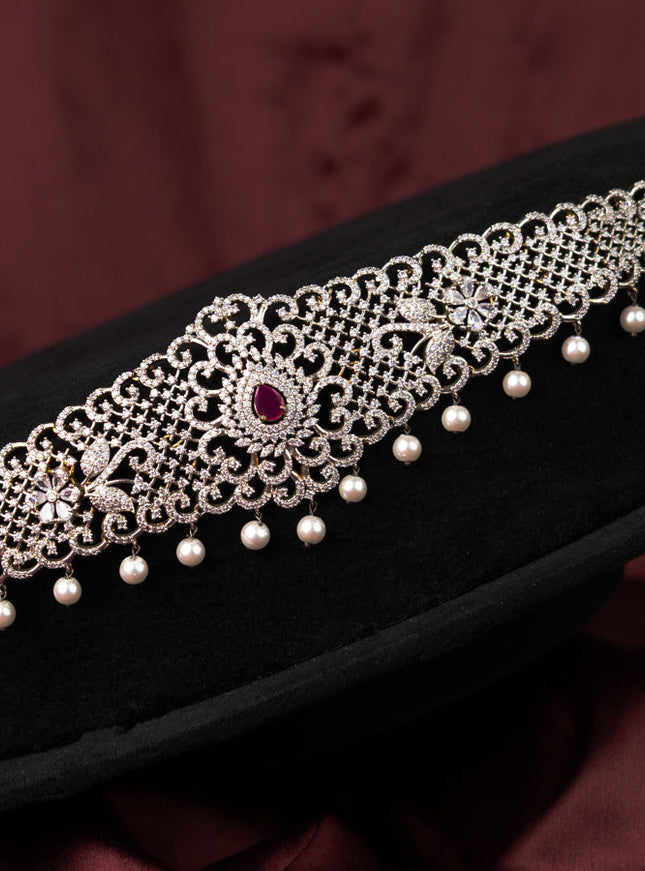 Zircon hip chain with ruby & cz stones and pearl hangings in gold finish