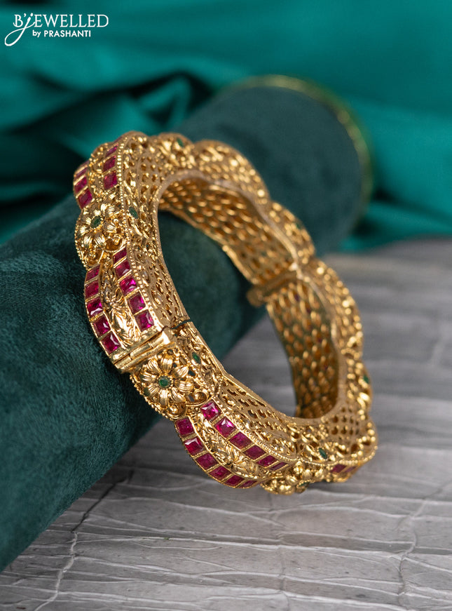 Antique kada bangle with floral design and kemp stones