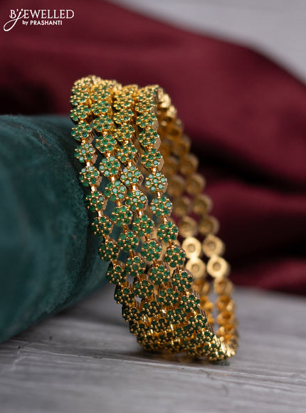 zircon bangle with and emerald stones in gold finish