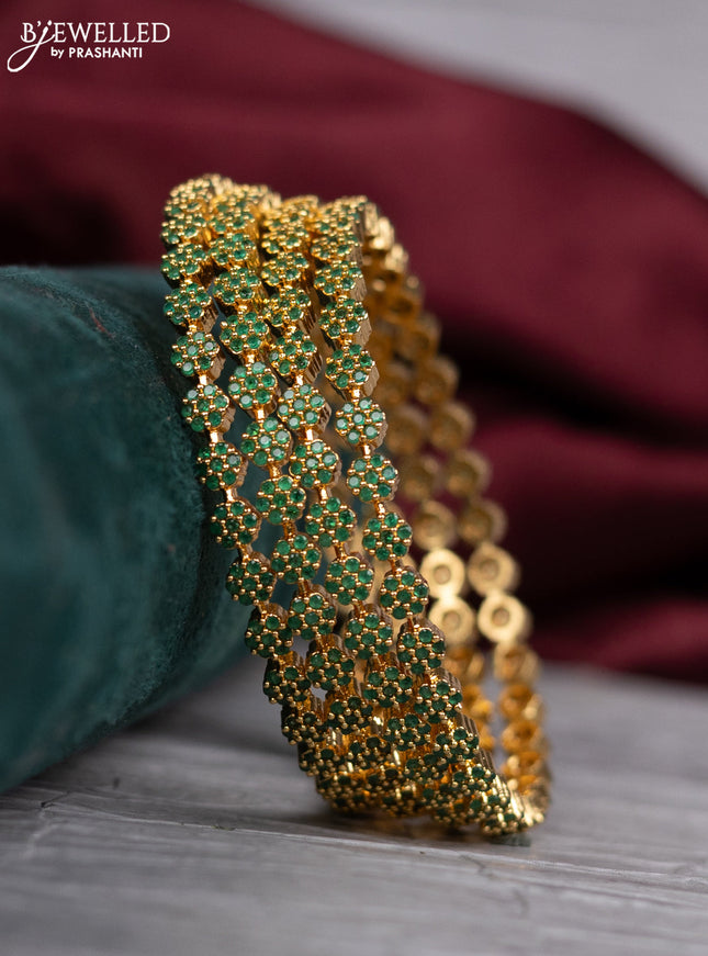 zircon bangle with and emerald stones in gold finish