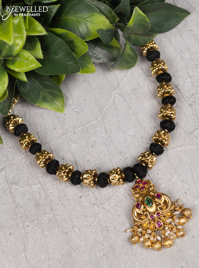 Black thread necklace with kemp stones and pearl hangings without earrings