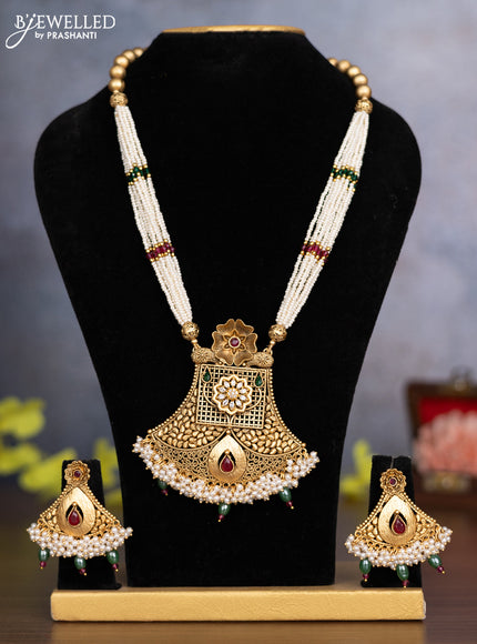 Pearl necklace floral design with kemp & cz stones and pearl & green beads hanging