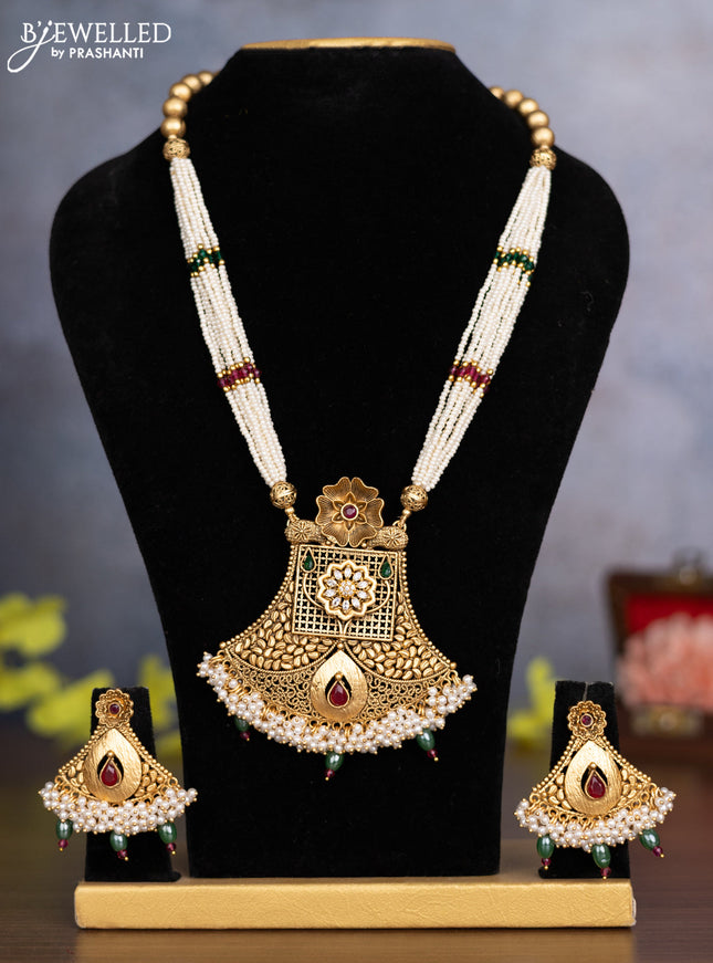 Pearl necklace floral design with kemp & cz stones and pearl & green beads hanging