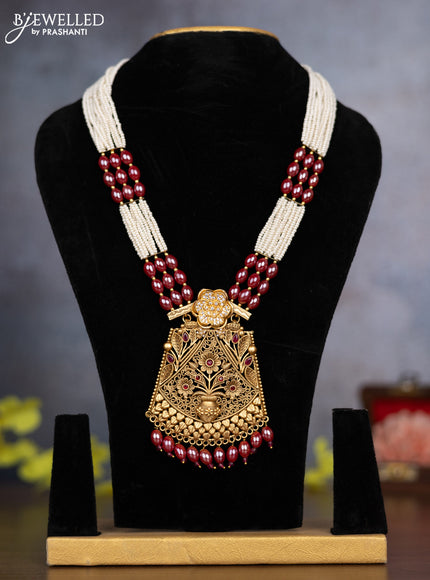Pearl necklace floral design with ruby & cz stones and pearl & pink beads hanging without earrings