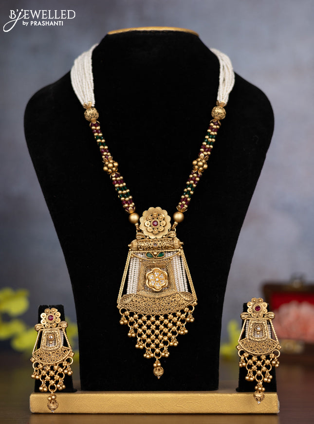 Pearl necklace with kemp & cz stones and golden beads hanging