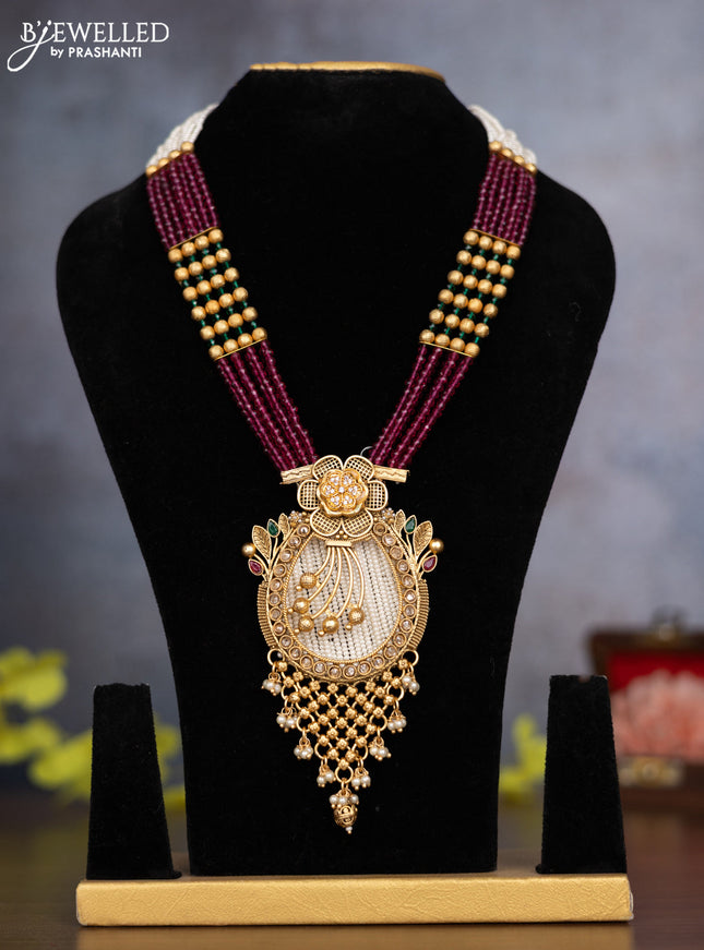 Pearl necklace floral design with kemp & cz stones and pearl & golden beads hanging without earrings