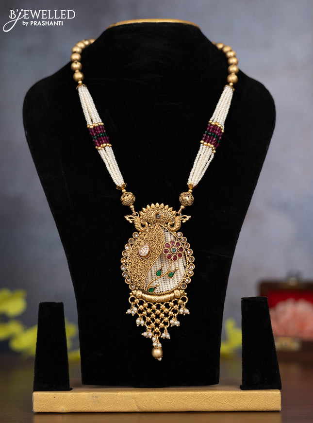 Pearl necklace floral design with kemp & cz stones and pearl & golden beads hanging without earrings