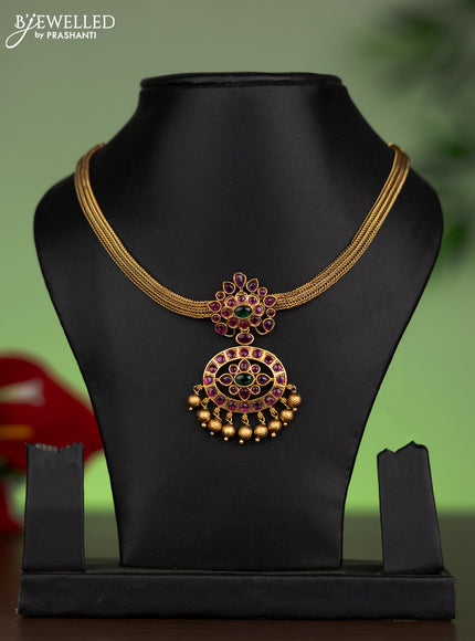 Antique attigai necklace with kemp stones and golden beads hanging without earring