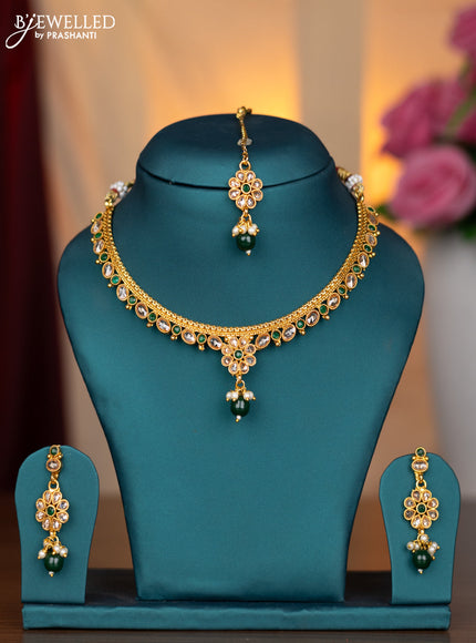 Antique necklace with emerald & cz stones and green beads hanging with maang tikka