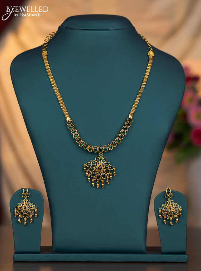 Antique necklace floral design with emerald stones and golden beads hanging