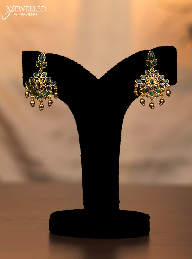 Antique necklace floral design with emerald stones and golden beads hanging