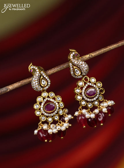Earring with peacock design ruby & cz stones and pearl & pink beads hanging in victorian finish