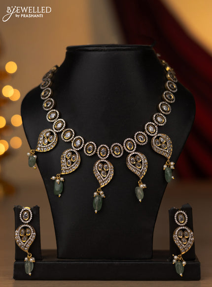 Necklace with leaf design white and cz stones