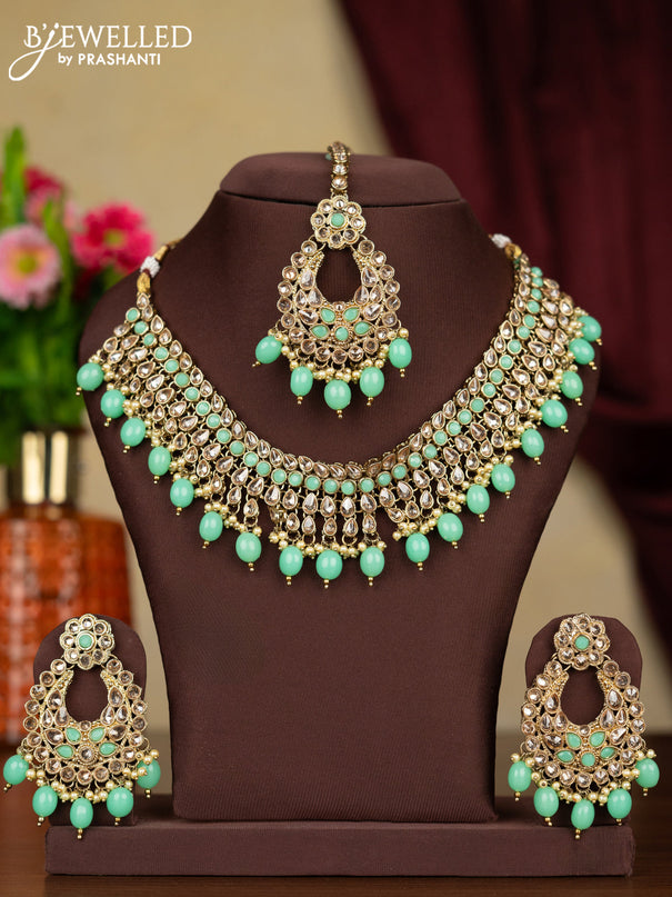 Kundan necklace mint green stones with maang tikka and pearl & mint green beads hanging