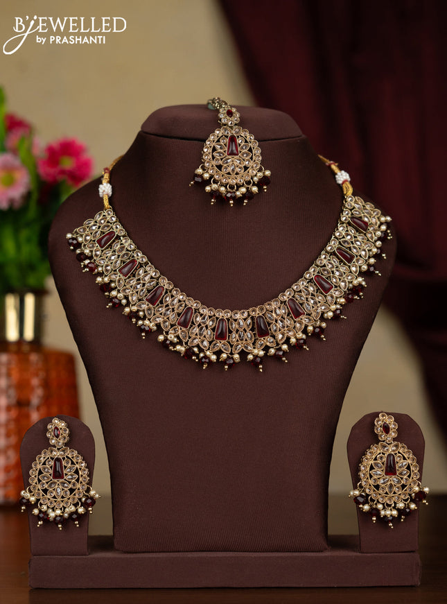 Kundan necklace ruby stones with maang tikka and pearl & maroon beads hanging
