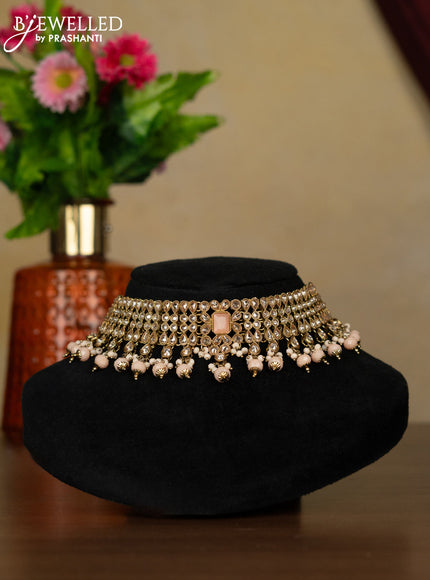 Kundan necklace with peach stones and peach beads hanging
