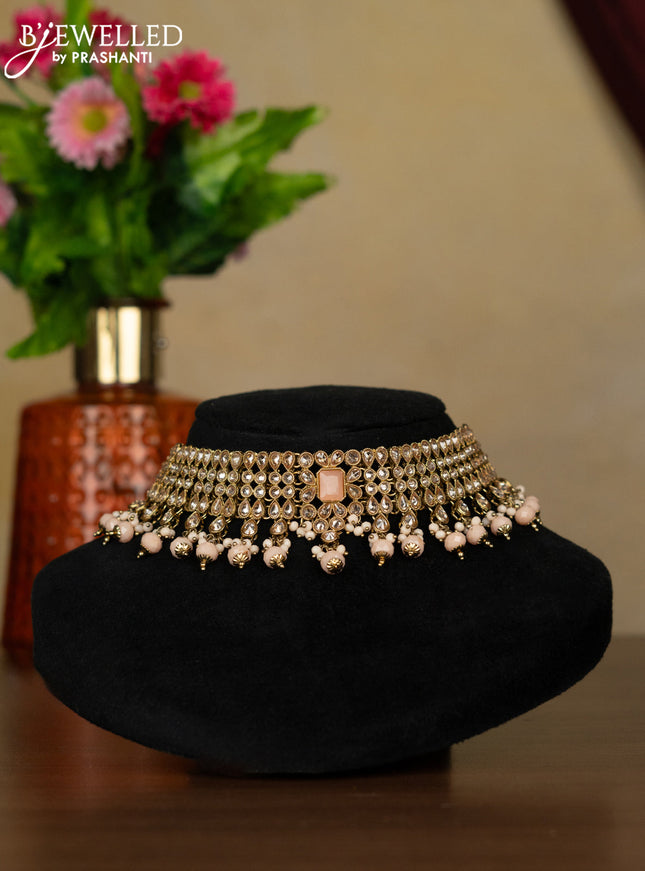 Kundan necklace with peach stones and peach beads hanging