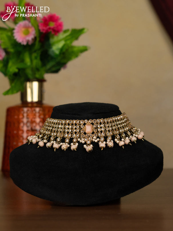 Kundan necklace with peach stones and peach beads hanging