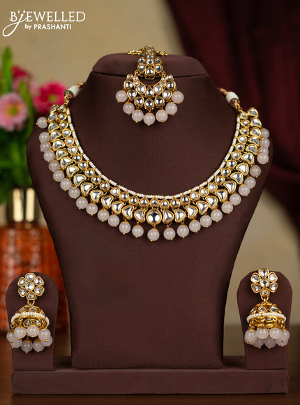 Kundan kundan necklace with maang tikka and baby pink beads hanging