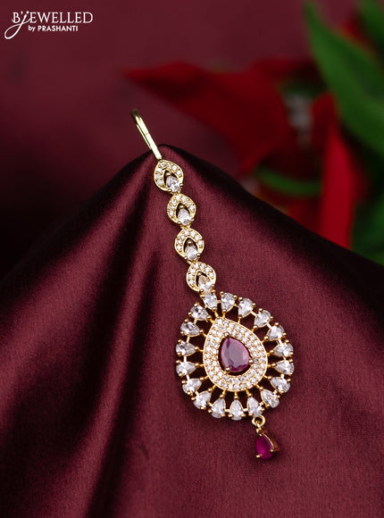 Zircon maang tikka with ruby & cz stones and hanings in gold finish
