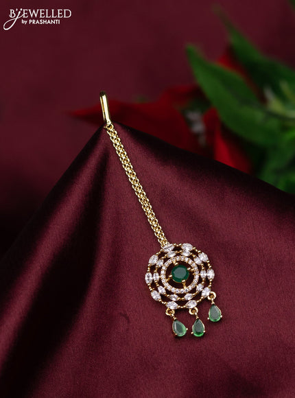 Zircon maang tikka with emerald & cz stones and hanings in gold finish