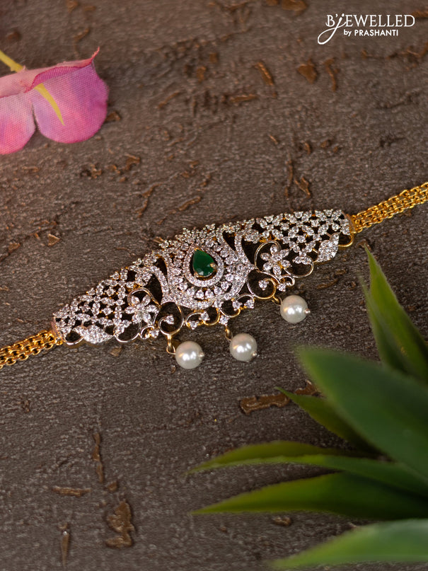 Zircon vanki with emerald & cz stones and pearl hangings in gold finish