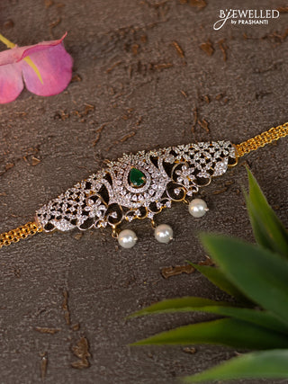 Zircon vanki with emerald & cz stones and pearl hangings in gold finish