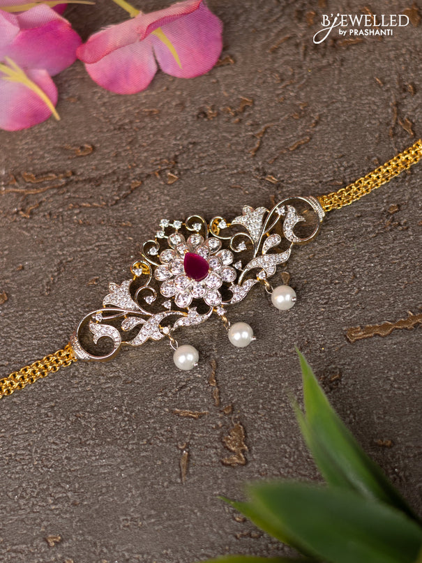 Zircon vanki with ruby & cz stones and pearl hangings in gold finish
