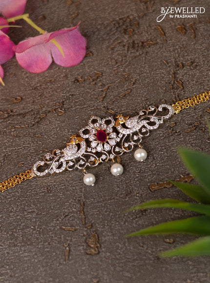 Zircon vanki peacock design with ruby & cz stones and pearl hangings in gold finish