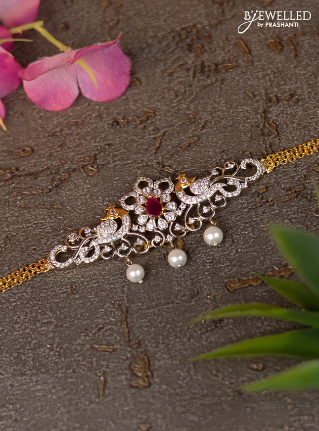 Zircon vanki with ruby & cz stones and pearl hangings in gold finish