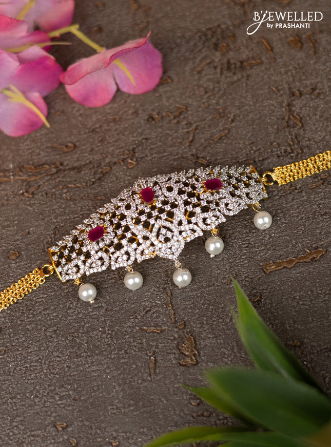 Zircon vanki with ruby & cz stones and pearl hangings in gold finish