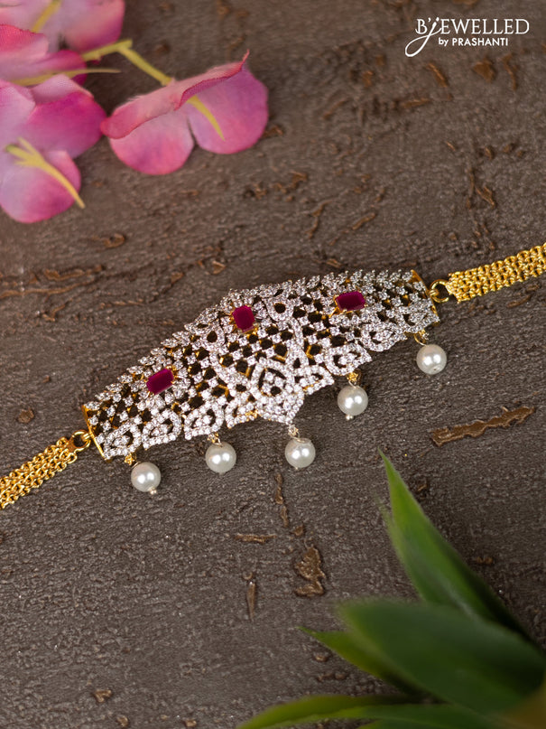 Zircon vanki with ruby & cz stones and pearl hangings in gold finish