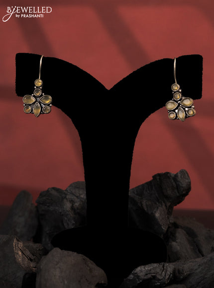Oxidised hanging type earrings with yellow stones