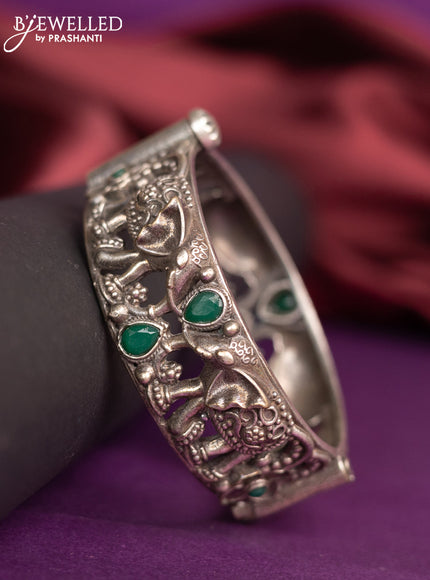 Oxidised elephant design screw type bangle with emerald stones