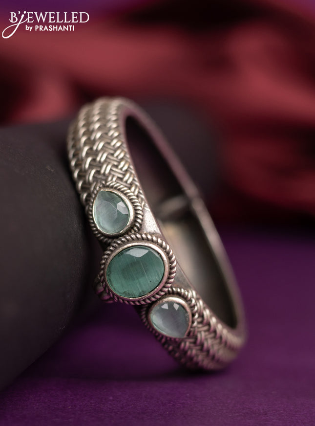 Oxidised screw type bangle with mint green stones
