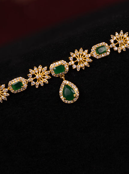 Zircon hip chain with emerald and cz stones in gold finish