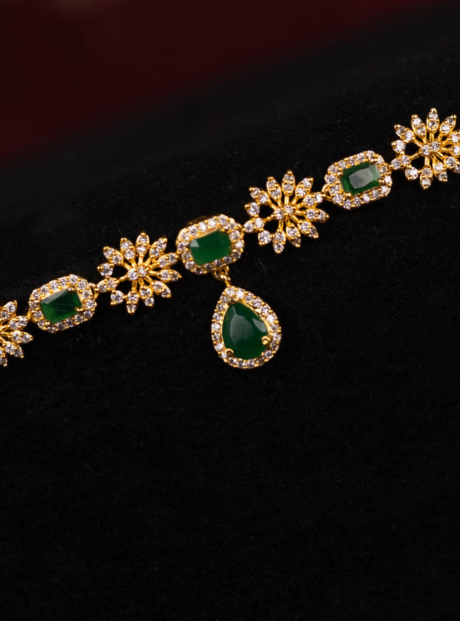 Zircon hip chain with emerald and cz stones in gold finish