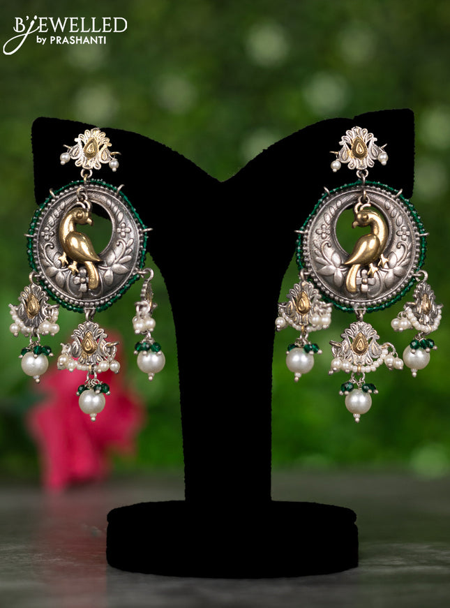 Oxidised earrings with peacock design and pearl & green beads hangings